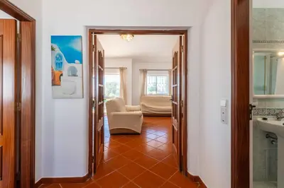 a hallway with a chair in a room at Villa Eulália in Guia