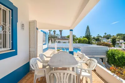 a table and chairs on the balcony of a house at Villa Eulália in Guia