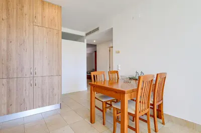 a dining room with a wooden table and chairs at Apartment with 2 bedrooms at Vilamoura Marina in Quarteira