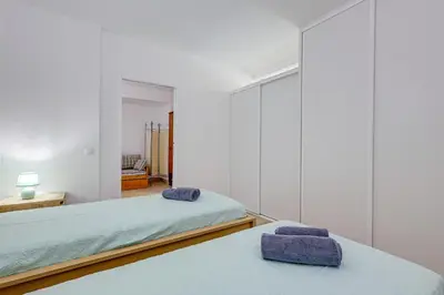 a bedroom with two beds and a mirror at Apartment with 2 bedrooms at Vilamoura Marina in Quarteira