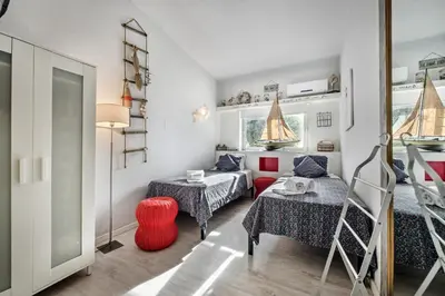 a bedroom with two beds and a mirror at SeaBreeze by Algarve Villa Holidays in Galé