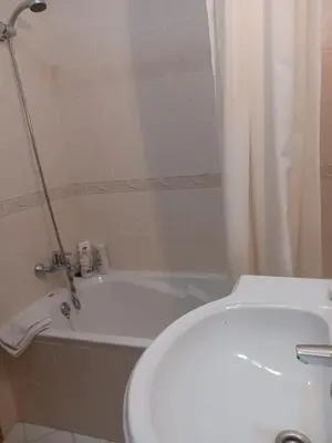 a bathroom with a white toilet and a bath tub at Sunbliss - praia, piscina e localização central in Albufeira