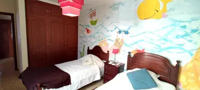 a bedroom with two beds and a colorful wall at Apt 3 Quartos, Terraço, Centro, Prestige For Home in Loulé