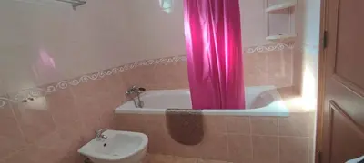a bathroom with a tub and a toilet and a pink curtain at Apt 3 Quartos, Terraço, Centro, Prestige For Home in Loulé