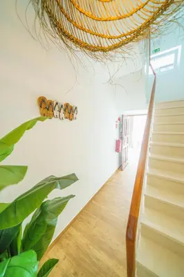a staircase in a living room with a plant at Casa Estrela do Mar in Albufeira