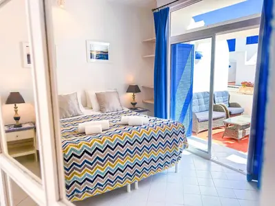 a bedroom with a bed and a living room at Ocean Breeze WindMill Condo by BeCherish in Albufeira