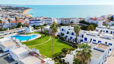 an aerial view of a resort with a pool and a beach at Ocean Breeze WindMill Condo by BeCherish in Albufeira