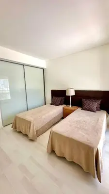 two beds in a large room with at Cavalo Preto Beach Resort in Quarteira
