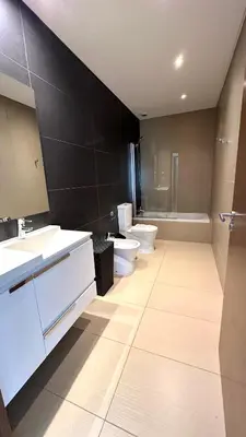 a bathroom with two sinks and two toilets at Cavalo Preto Beach Resort in Quarteira