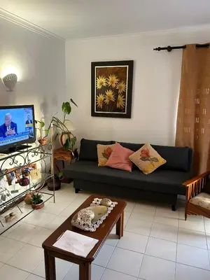 a living room with a couch and a coffee table at Nice Flat in Quarteira Beach in Quarteira