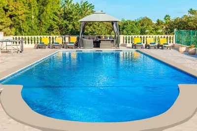 a pool with chairs and a gazebo at Villa Paloma by Algarve Vacation in Albufeira