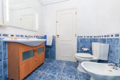 a blue and white bathroom with a sink and a toilet at Villa Paloma by Algarve Vacation in Albufeira