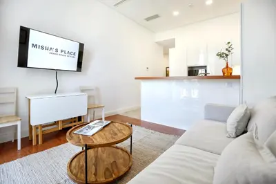 a living room with a couch and a table at Nap in the shade Apartment in Faro