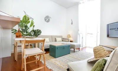 a living room with a couch and a table at Maison Faro Luxe - A Tranquil Retreat by the Algarve Coast in Faro