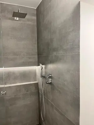 a bathroom with a shower with a shower head at Casa Mocha Vale do lobo 2 bed apartment in Loulé