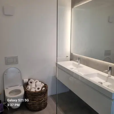 a bathroom with a sink and a toilet and a mirror at Casa Mocha Vale do lobo 2 bed apartment in Loulé