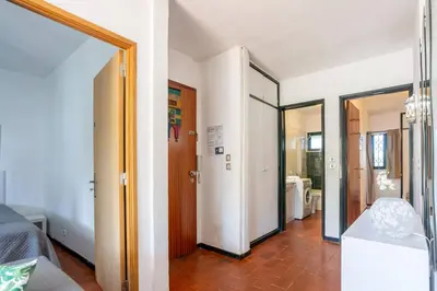 a room with a hallway with a door and a mirror at Azure Vilamoura Apartment by HelloVacations in Loulé