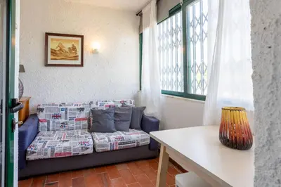 a room with a bed and a table and a window at Azure Vilamoura Apartment by HelloVacations in Loulé