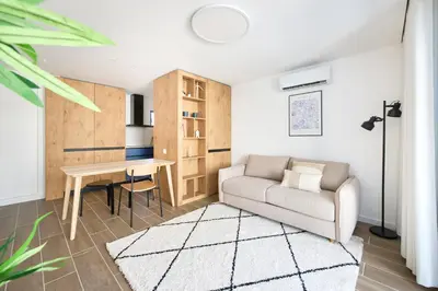 a living room with a couch and a table at Amazing Flat, 100m from beach in Quarteira