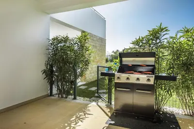 an outdoor kitchen with a stove and some plants at Blue by Algarve Villa Holidays in Albufeira