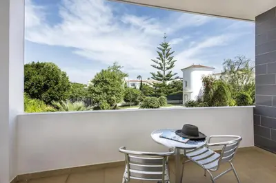 a balcony with a table and chairs and a window at Blue by Algarve Villa Holidays in Albufeira