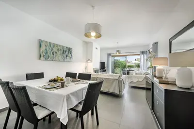 a kitchen and dining room with a table and chairs at Blue by Algarve Villa Holidays in Albufeira
