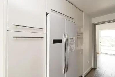 a white refrigerator in a kitchen with a window at Serenity 18 House by Stay ici Algarve Holiday Rental in Albufeira