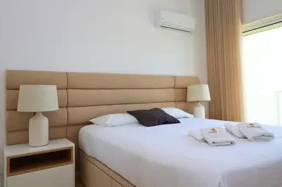 a bedroom with a white bed with two towels on it at Serenity 18 House by Stay ici Algarve Holiday Rental in Albufeira