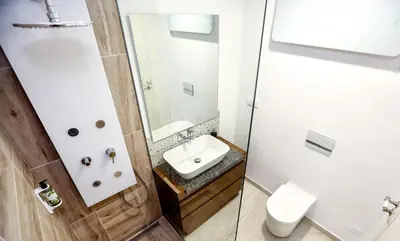 a bathroom with a sink and a toilet at Green Essence Duplex in Faro by Misha's Place in Faro