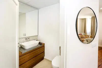 a bathroom with a mirror and a sink at Green Essence Duplex in Faro by Misha's Place in Faro