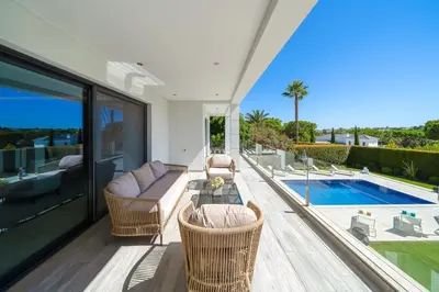 a dining room with a table and some chairs at Villa Sole in Quinta do Lago by LovelyStay in Faro