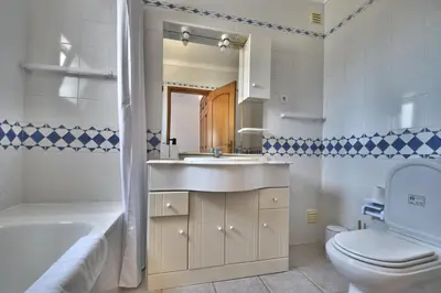 a bathroom with a sink and a toilet and a tub at Villa Santa Maria Valley - Private Pool in Albufeira