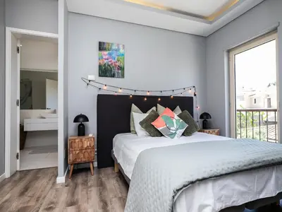 a bedroom with a bed and a large window at Villa Ada in Faro