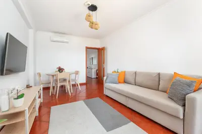 a living room with a couch and a table at BnB Homes Apartment with cozy Terrace & 2 Swimming pools near the heart city in Albufeira