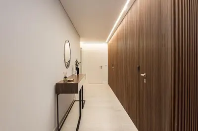 a hallway with a vanity and a mirror and a wooden wall at Terracos de Quarteira -Luxury Duplex Penthouse 3BR Best View, 50m from Beach in Quarteira