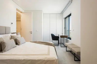 a bedroom with a bed and a chair and a desk at Terracos de Quarteira -Luxury Duplex Penthouse 3BR Best View, 50m from Beach in Quarteira