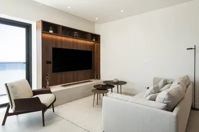 a living room with a couch and a tv at Terracos de Quarteira -Luxury Duplex Penthouse 3BR Best View, 50m from Beach in Quarteira