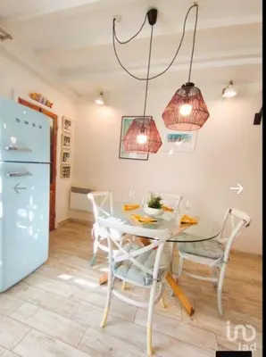 a kitchen with a table and chairs and a refrigerator at Cozy House in Center in Faro