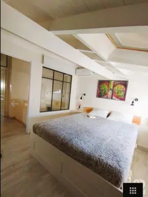 a bedroom with a large bed and two windows at Cozy House in Center in Faro