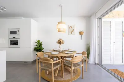 a dining room with a table and chairs at Stylish 3-Bedroom Villa Haven with a Private Pool in Albufeira