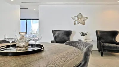 a dining room with chairs and a table with wine glasses at Villa Malibu - Onesix2, Cleverdetails CD 285 in Vilamoura