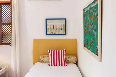 a room with two beds and a table with a lamp at Almancil Sea and Countryside Secluded Villa in Quartos