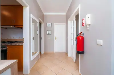 a kitchen with a red fire hydrant on the wall at Calm Paradise close to the City in Faro