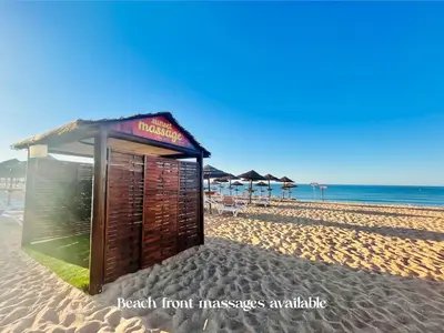 a small shack on a beach with the ocean at BrisaMar Villas: Sol, Mar, Serenidade in Albufeira