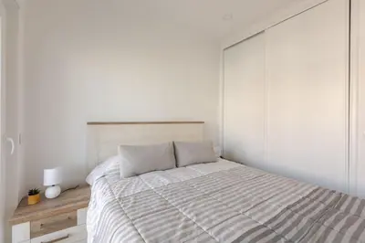 a white bedroom with a bed and a white wall at BrisaMar Villas 2 Sol Mar Serenidade in Albufeira