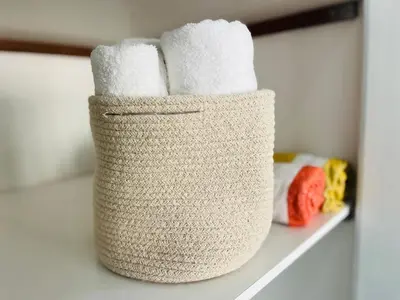 a basket filled with towels sitting on a shelf at BrisaMar Villas 2 Sol Mar Serenidade in Albufeira