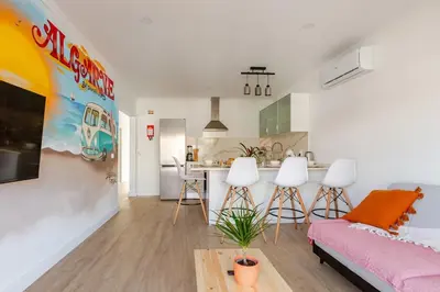 a living room and kitchen with a couch and a table at BrisaMar Villas 2 Sol Mar Serenidade in Albufeira