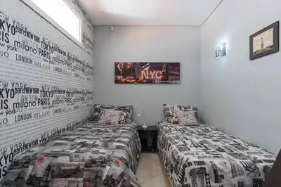 a bedroom with two beds and a wall with a picture at VilamouraSun Aquamar Penthouse 601 in Quarteira