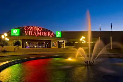 a fountain in front of a shopping center at night at VilamouraSun Aquamar Penthouse 601 in Quarteira