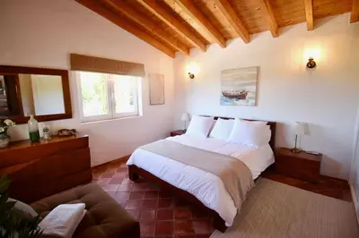 a bedroom with a large bed and a couch at Casa Grayson in Loulé